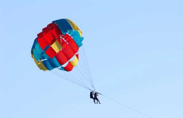 Parasailing and jet skiing over bright Atlantic waters.