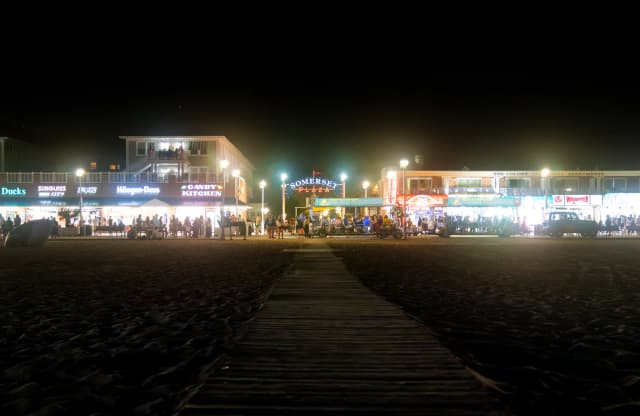 Live band and neon-lit bar scene by the Ocean City bay.