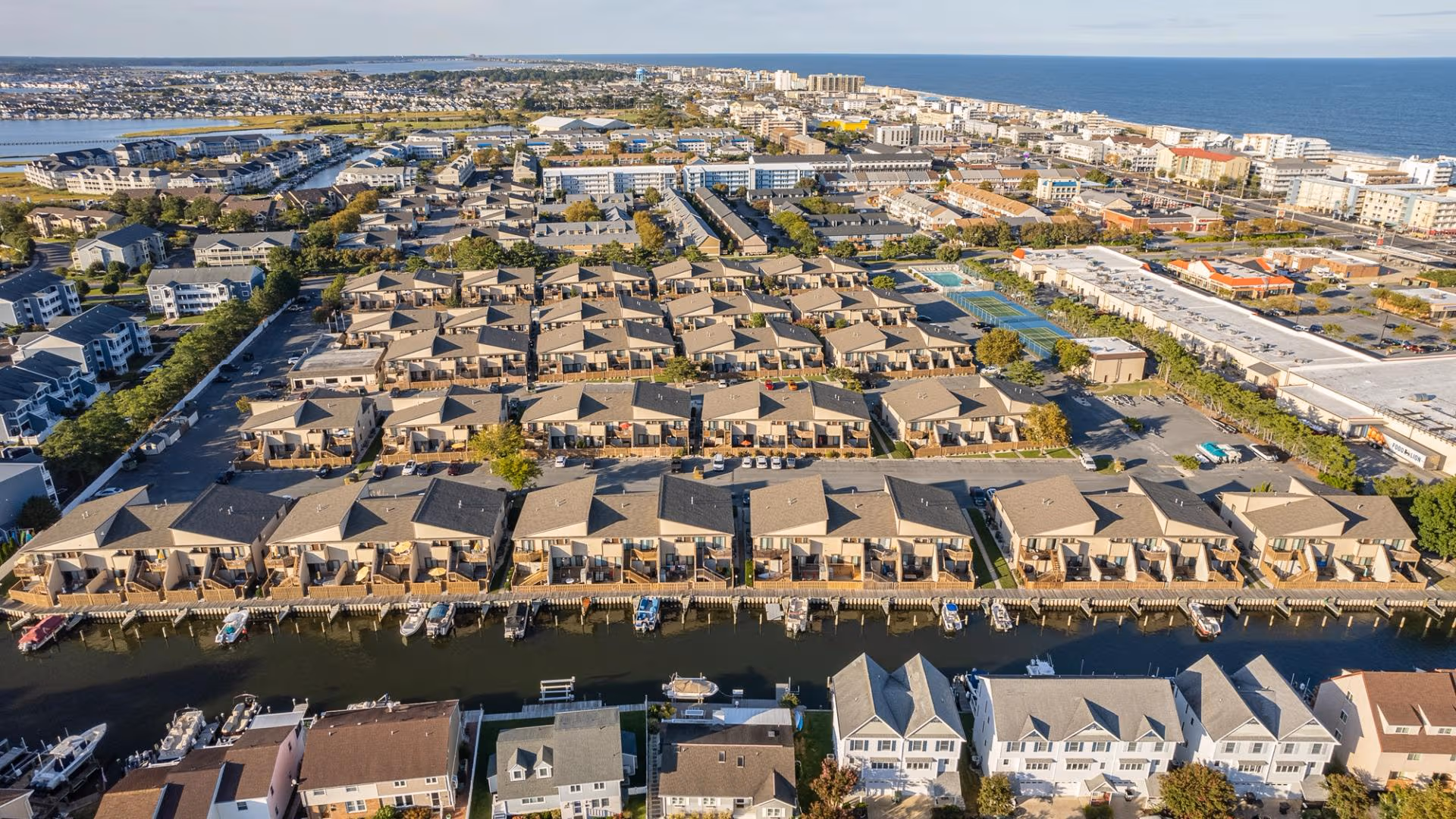 Aerial view of the resort property surrounded by palm trees and coastline