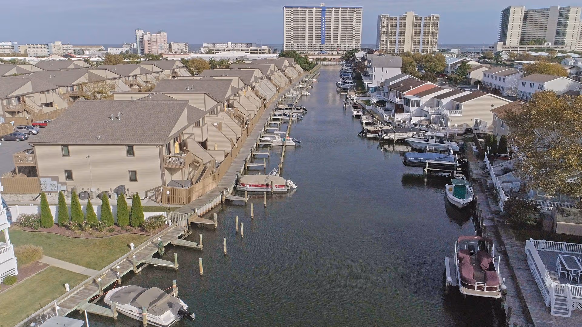 Drone photo of resort dock with boats along the shoreline