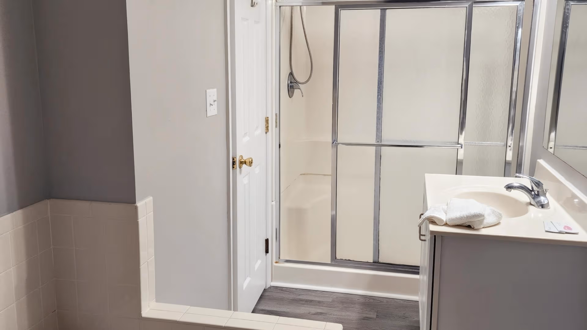 Spacious resort bathroom with vanity, mirror, and modern lighting