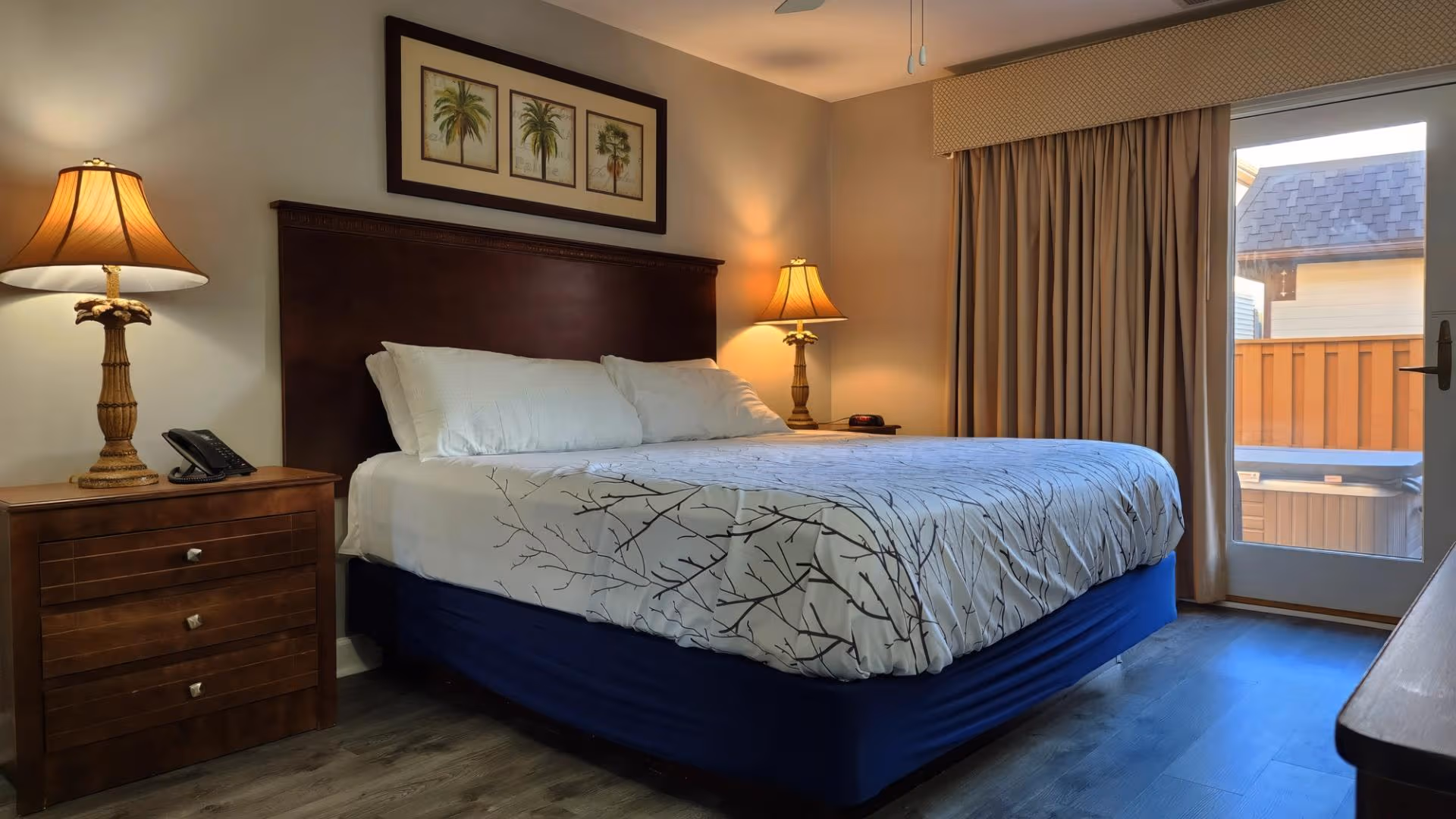 Cozy bedroom with queen bed, nightstand, and soft bedding